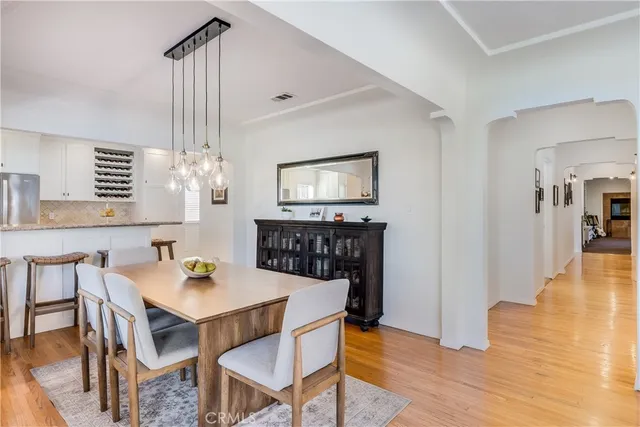 a view of a dining room with furniture wooden floor and chandelier