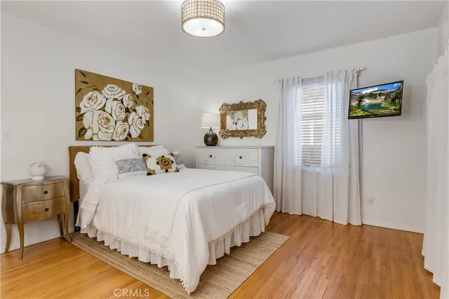a bedroom with bed and painting on the wall
