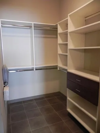 a room with a closet and wooden floor