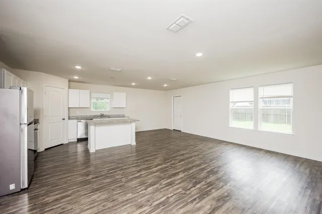 a view of kitchen with wooden floor and window