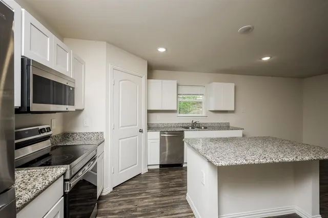 a kitchen with a sink stove and refrigerator