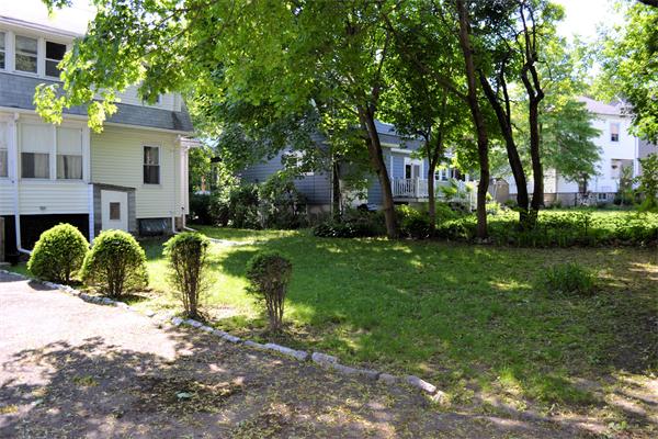 11 Sunset Road Cambridge, MA 02138 - Photo 3 of 18 a view of a white house with a big yard and large trees