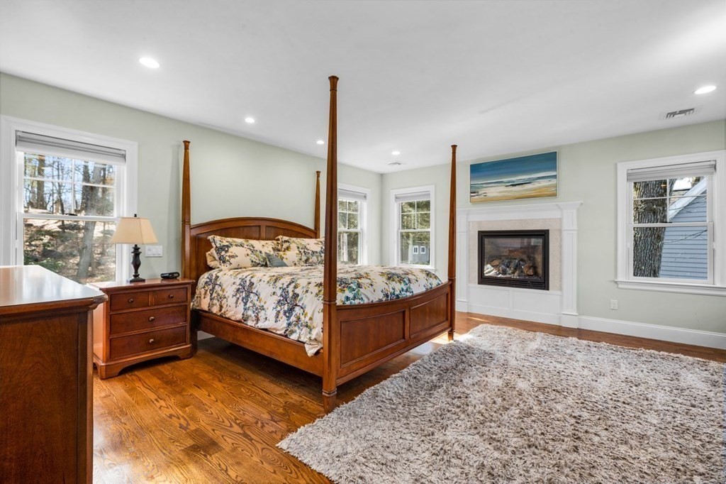 36 Newbrook Circle Newton, MA 02467 - Photo 18 of 29 a bedroom with a bed window and a fireplace