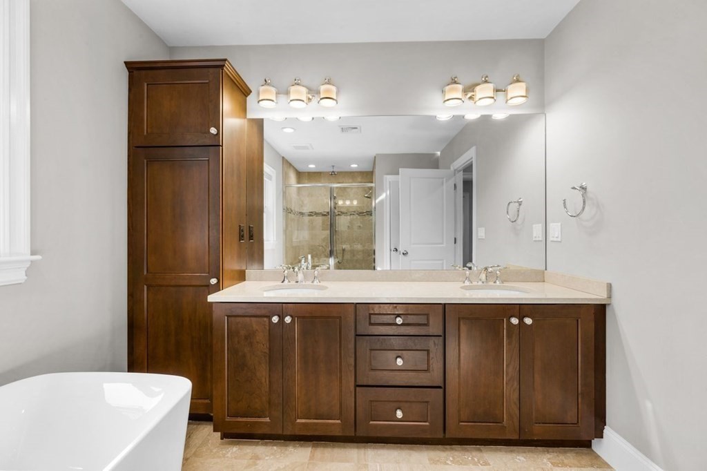 36 Newbrook Circle Newton, MA 02467 - Photo 20 of 29 a bathroom with a granite countertop sink a toilet a mirror and bathtub