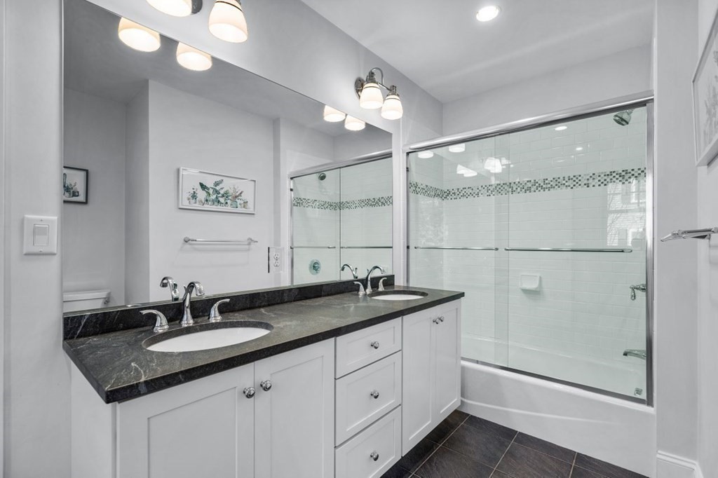 36 Newbrook Circle Newton, MA 02467 - Photo 23 of 29 a bathroom with a granite countertop sink a large mirror and a shower