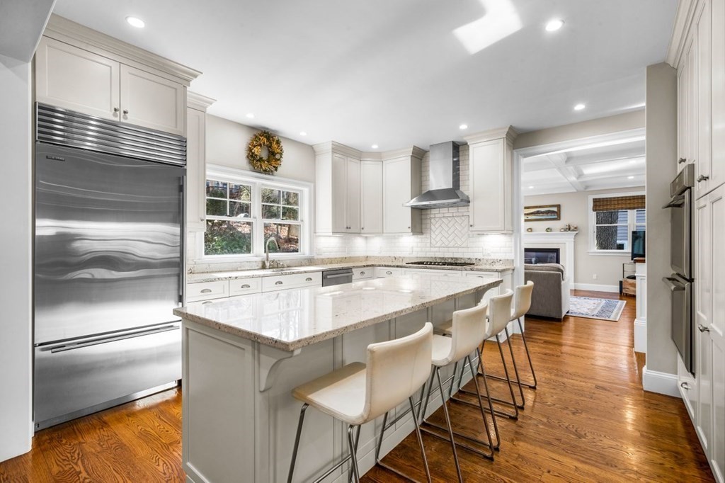 36 Newbrook Circle Newton, MA 02467 - Photo 10 of 29 a kitchen with stainless steel appliances granite countertop a refrigerator a stove and a sink with wooden floor