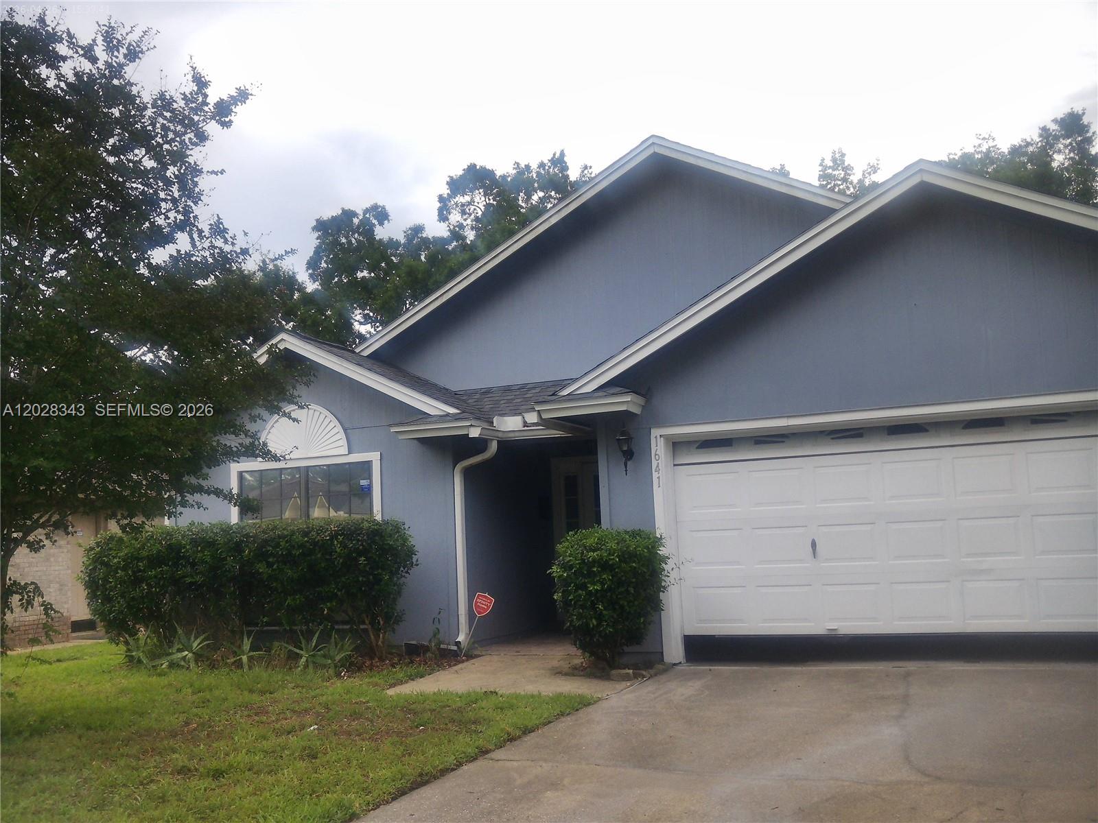 1641 Spring Oaks Lane Jacksonville, FL 32221 - Photo 44 of 44 a view of a house with a yard plants and a large tree