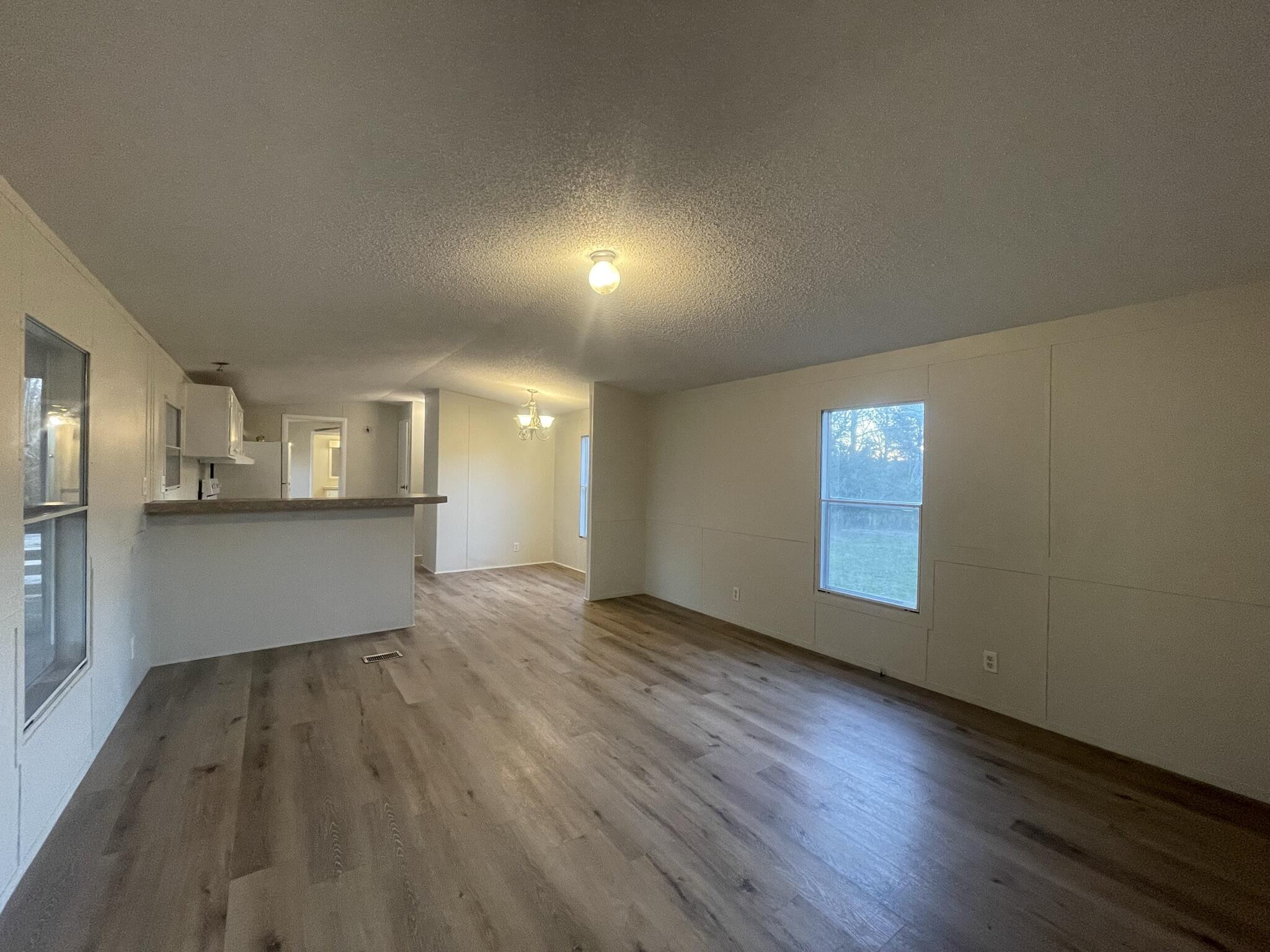 5472 Elzie Road Baker, FL 32531 - Photo 6 of 16 a view of empty room with wooden floor