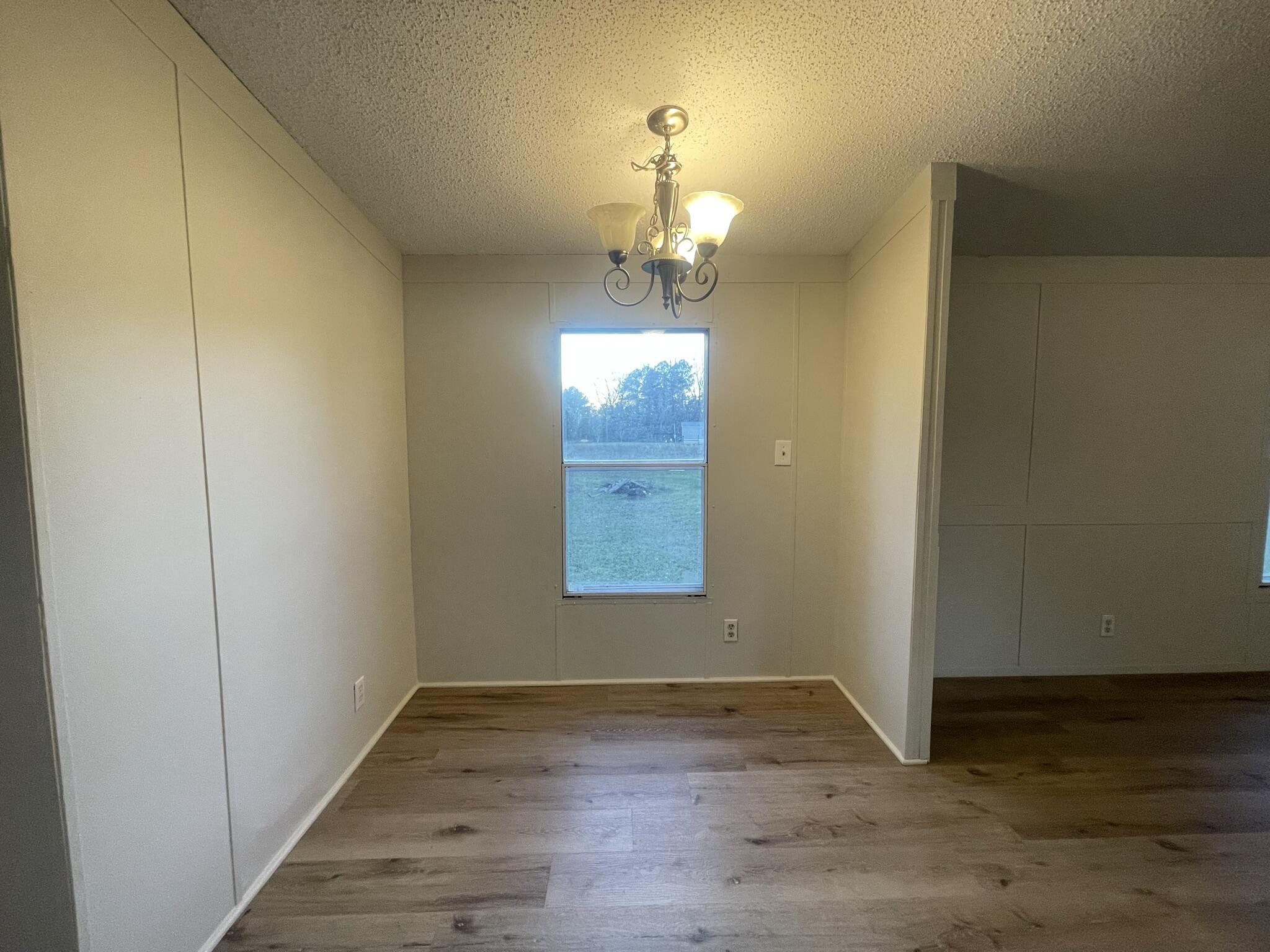 5472 Elzie Road Baker, FL 32531 - Photo 8 of 16 a view of empty room with wooden floor and fan