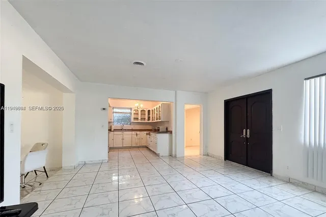 a view of a kitchen with a sink and dishwasher cabinets