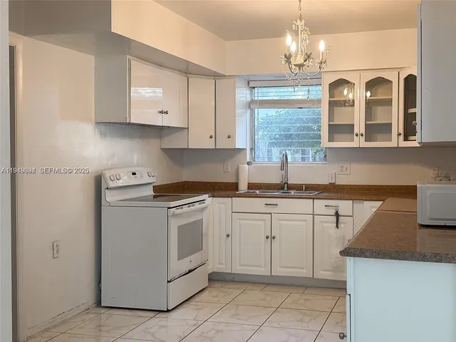 a kitchen that has a lot of cabinets in it