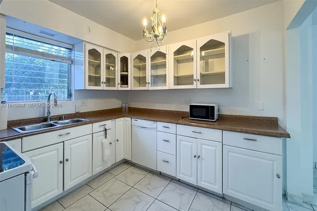 a kitchen with stainless steel appliances granite countertop a sink and cabinets