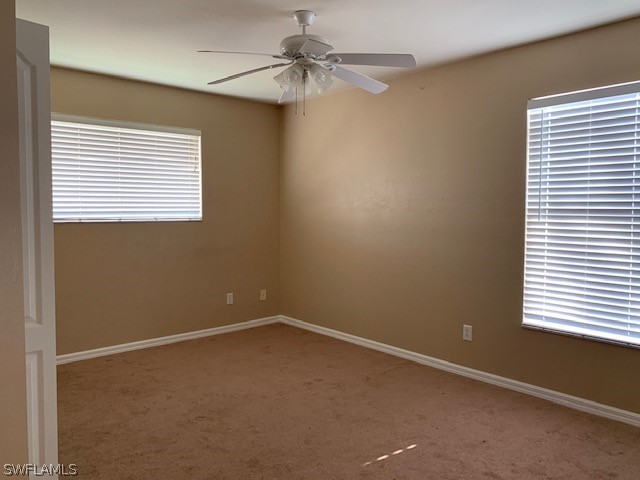 21549 Windham Run Estero, FL 33928 - Photo 17 of 21 an empty room with a window and a fan