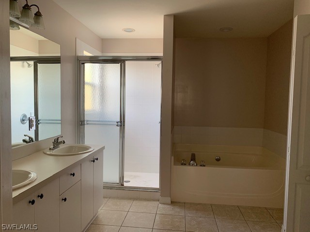 21549 Windham Run Estero, FL 33928 - Photo 18 of 21 a bathroom with a tub sink and mirror