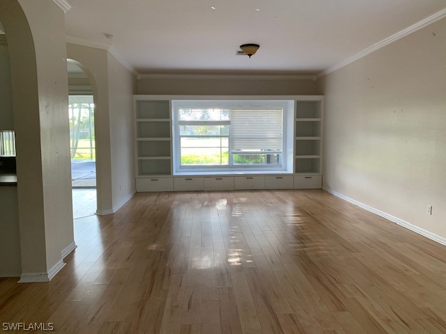 21549 Windham Run Estero, FL 33928 - Photo 3 of 21 an empty room with wooden floor and windows