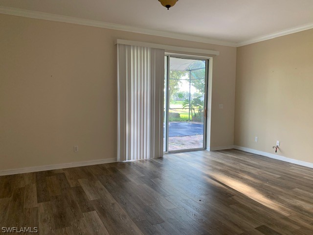 21549 Windham Run Estero, FL 33928 - Photo 5 of 21 an empty room with wooden floor and windows