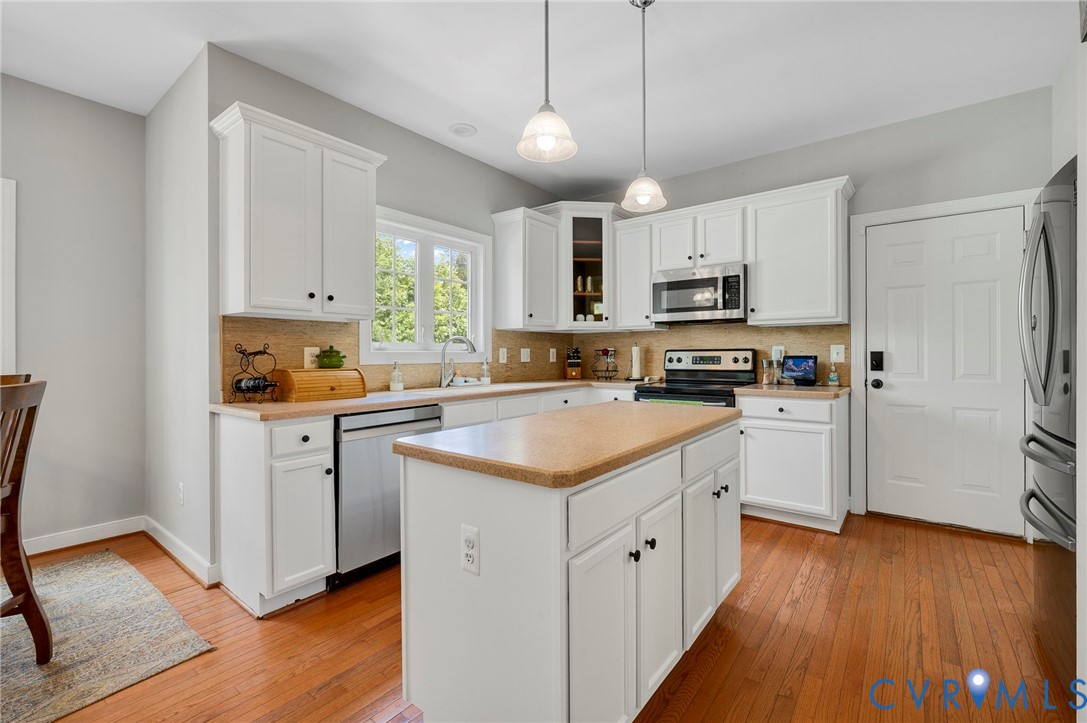 3090 Poor House Road Goochland, VA 23063 - Photo 8 of 32 Bright kitchen featuring white cabinetry, a center