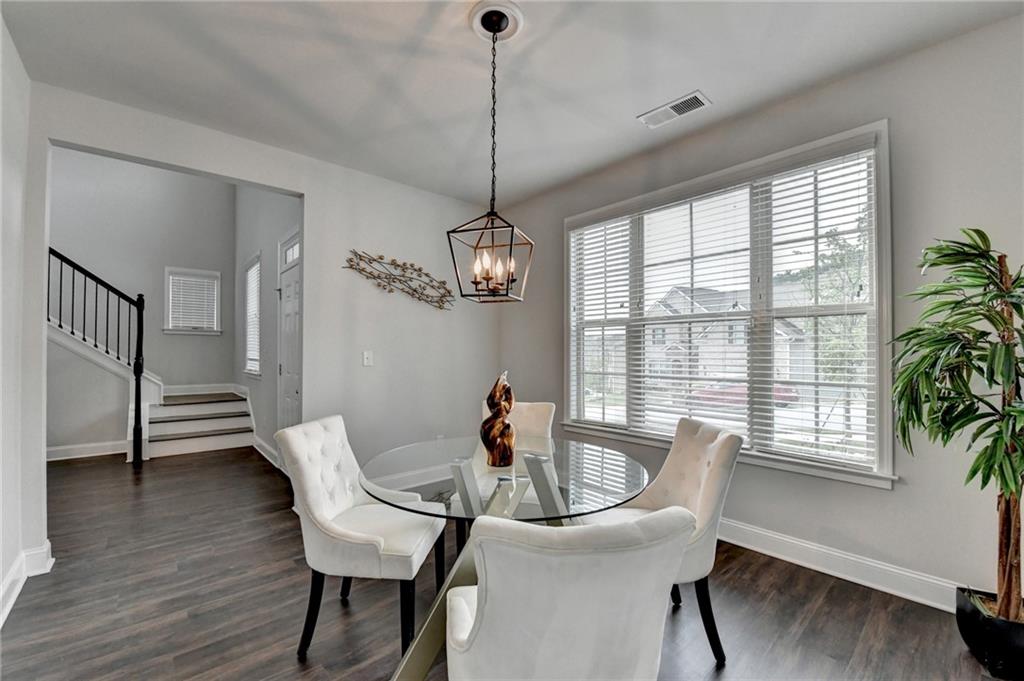 2017 Yvette Way Braselton, GA 30517 - Photo 11 of 75 a view of a dining room with furniture window and wooden floor