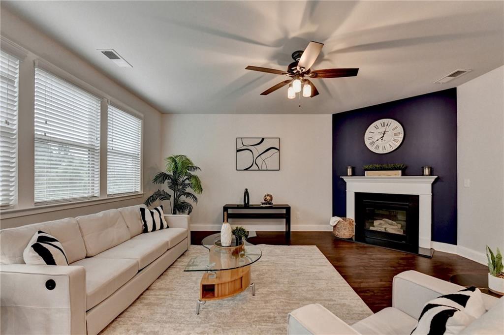 2017 Yvette Way Braselton, GA 30517 - Photo 26 of 75 a living room with furniture a fireplace with window and a fireplace