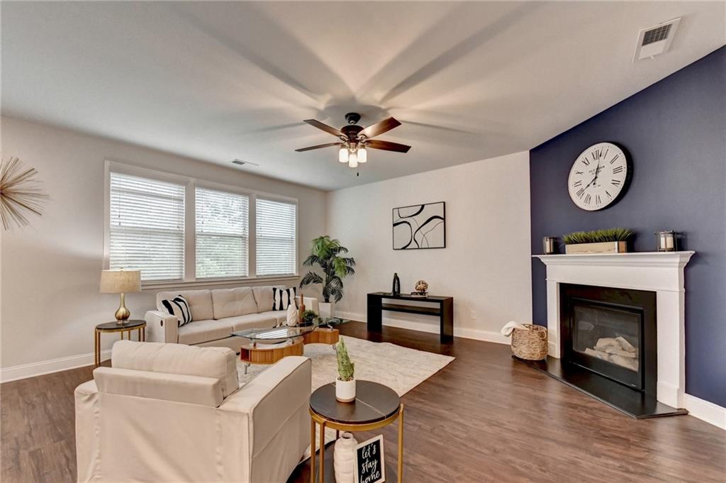 2017 Yvette Way Braselton, GA 30517 - Photo 27 of 75 a living room with furniture a fireplace and a large window