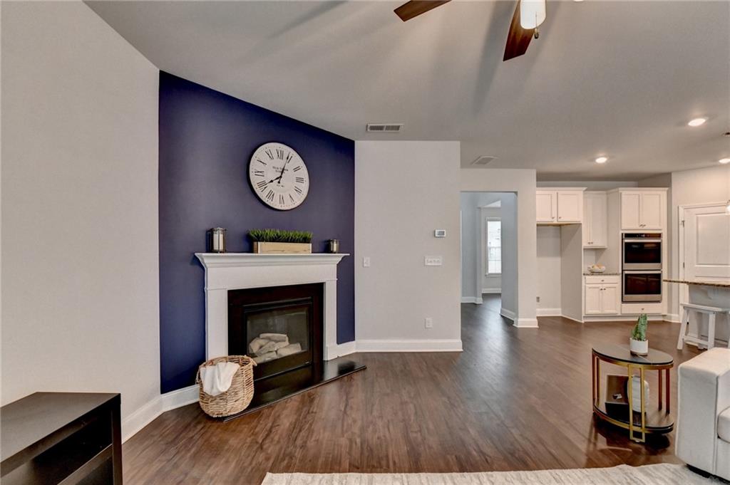 2017 Yvette Way Braselton, GA 30517 - Photo 31 of 75 a view of a livingroom with furniture wooden floor a fireplace and a window