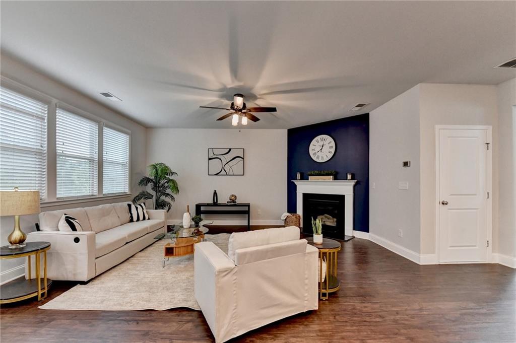 2017 Yvette Way Braselton, GA 30517 - Photo 39 of 75 a living room with furniture a fireplace and a large window