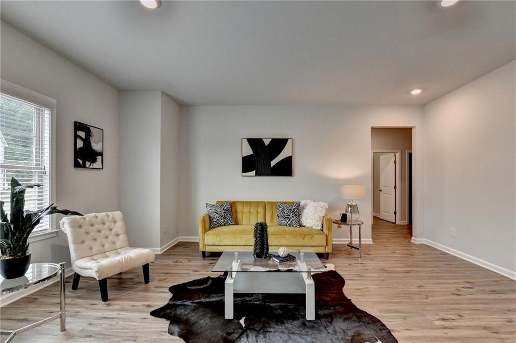 2017 Yvette Way Braselton, GA 30517 - Photo 44 of 75 a living room with furniture and a wooden floor