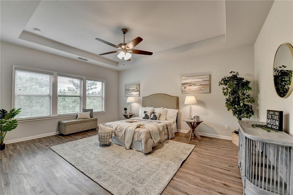 2017 Yvette Way Braselton, GA 30517 - Photo 46 of 75 a bedroom with a large bed a chandelier and windows