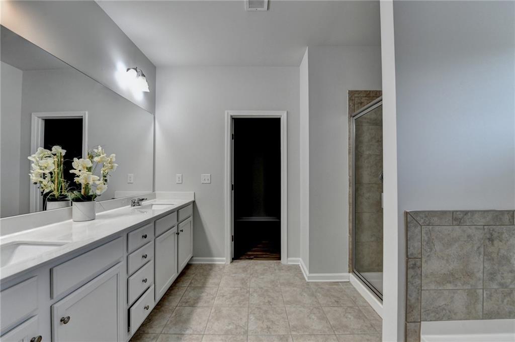 2017 Yvette Way Braselton, GA 30517 - Photo 52 of 75 a bathroom with a double vanity sink and a mirror