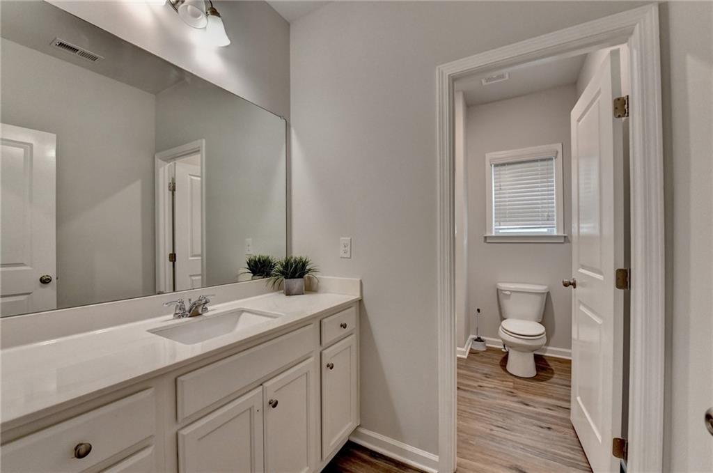 2017 Yvette Way Braselton, GA 30517 - Photo 60 of 75 a bathroom with a double vanity sink and a mirror