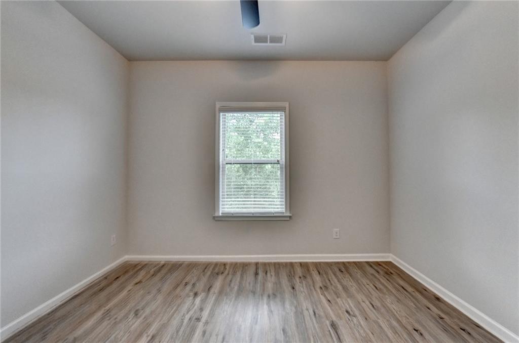 2017 Yvette Way Braselton, GA 30517 - Photo 63 of 75 an empty room with wooden floor and windows