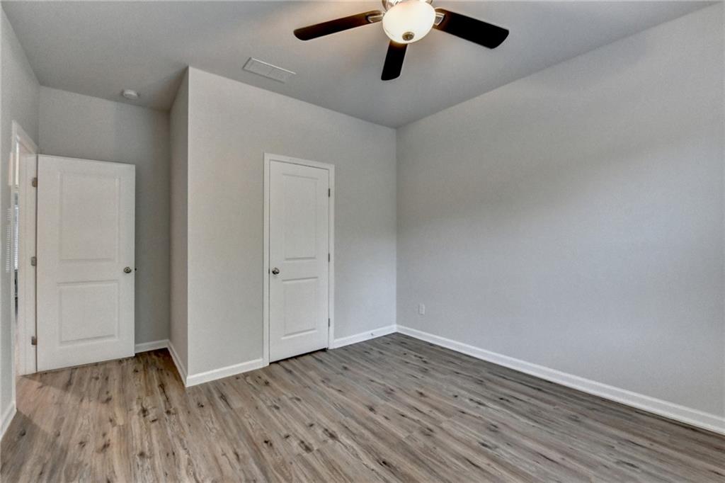 2017 Yvette Way Braselton, GA 30517 - Photo 65 of 75 an empty room with a hardwood and ceiling fan