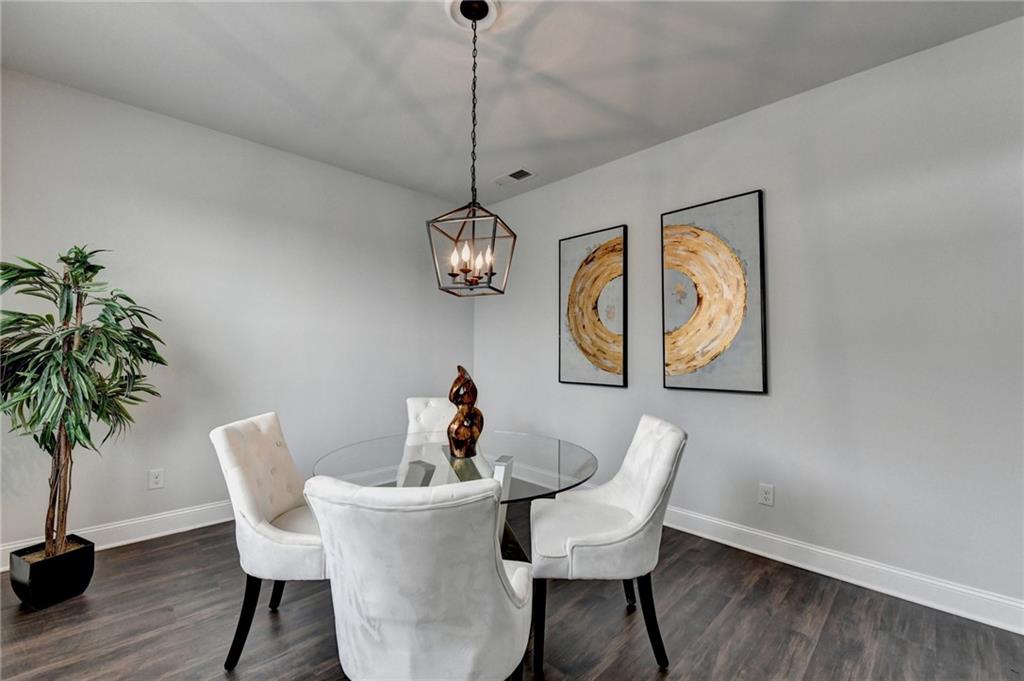 2017 Yvette Way Braselton, GA 30517 - Photo 9 of 75 a view of a dining room with furniture wooden floor and chandelier