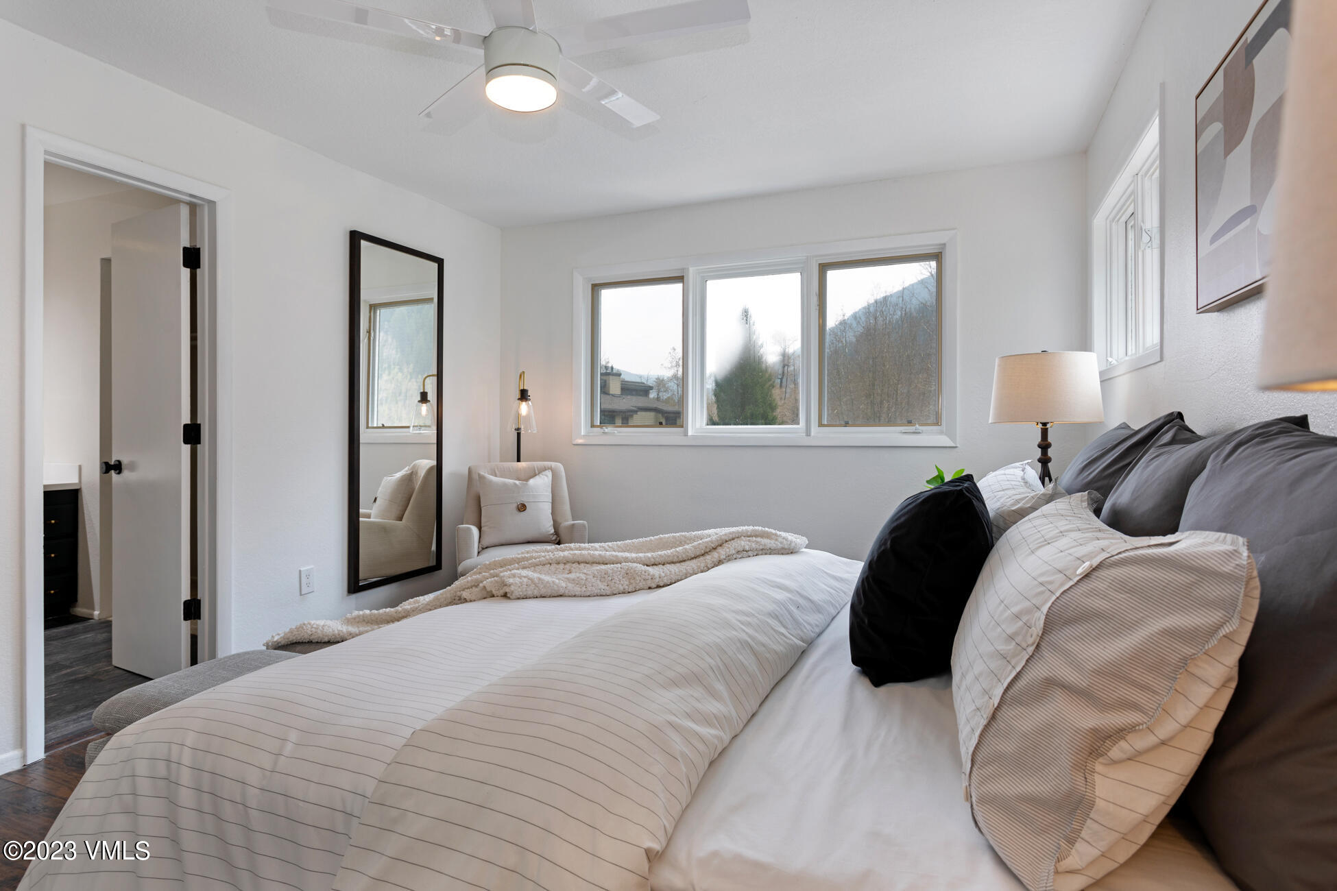 3910 Fall Line Drive, Unit 19 Vail, CO 81657 - Photo 16 of 40 a bedroom with a bed and a large mirror