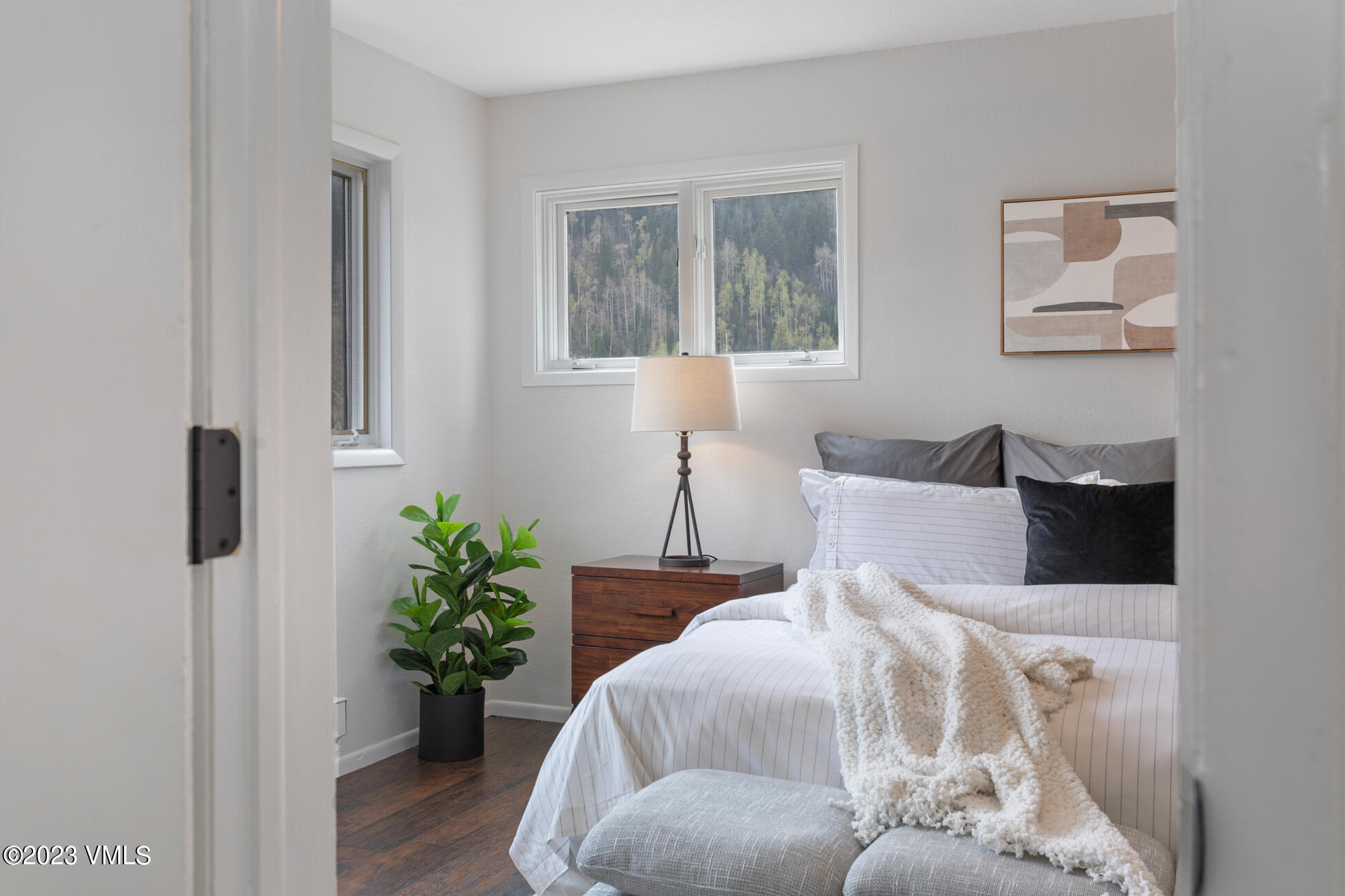 3910 Fall Line Drive, Unit 19 Vail, CO 81657 - Photo 18 of 40 a bed sitting in a bedroom next to a window with potted plant