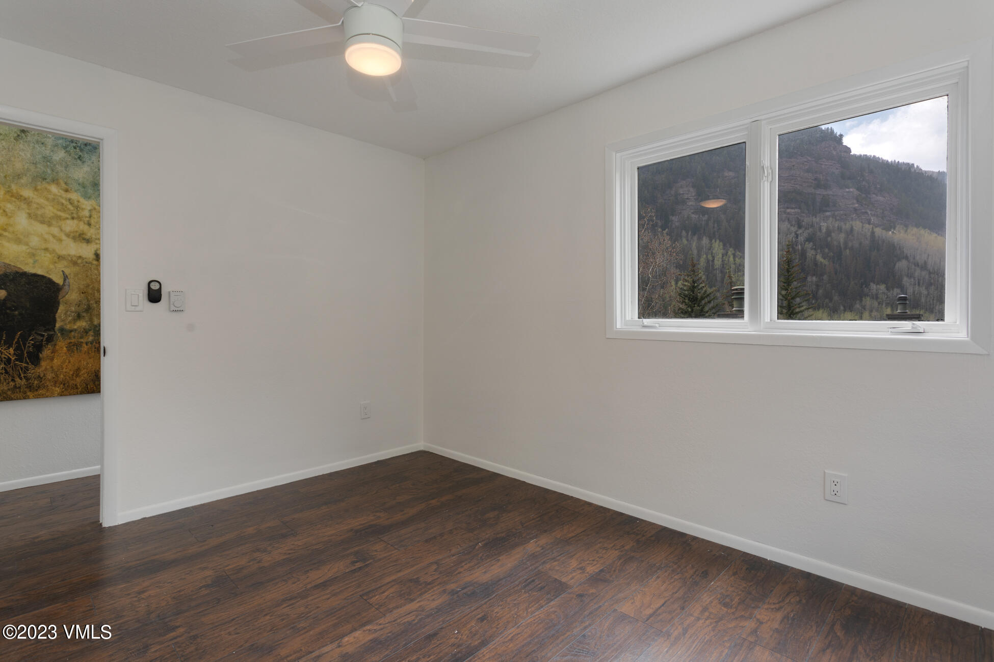 3910 Fall Line Drive, Unit 19 Vail, CO 81657 - Photo 20 of 40 an empty room with wooden floor and windows