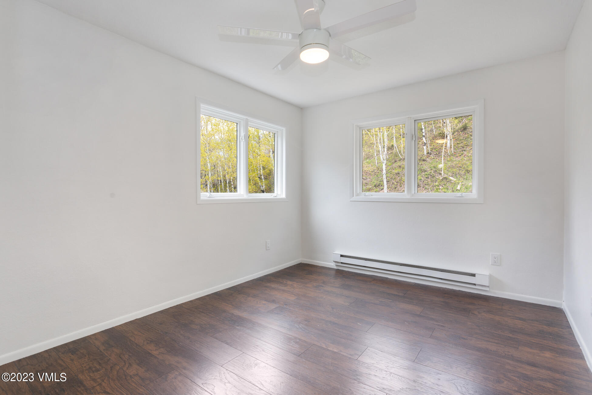 3910 Fall Line Drive, Unit 19 Vail, CO 81657 - Photo 23 of 40 an empty room with wooden floor and windows
