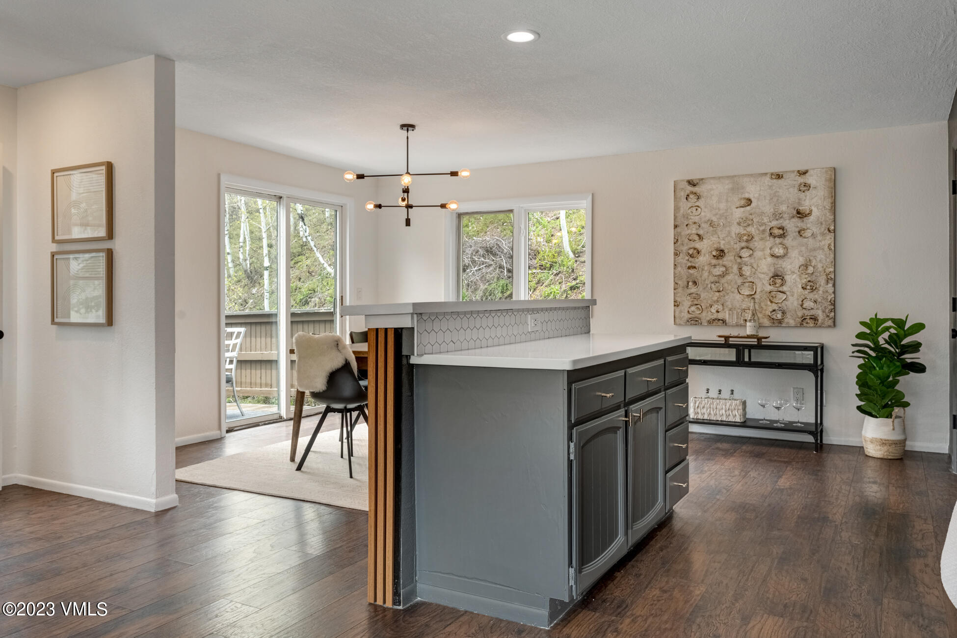 3910 Fall Line Drive, Unit 19 Vail, CO 81657 - Photo 8 of 40 a kitchen with stainless steel appliances granite countertop a stove a refrigerator a sink a dining table and chairs with wooden floor