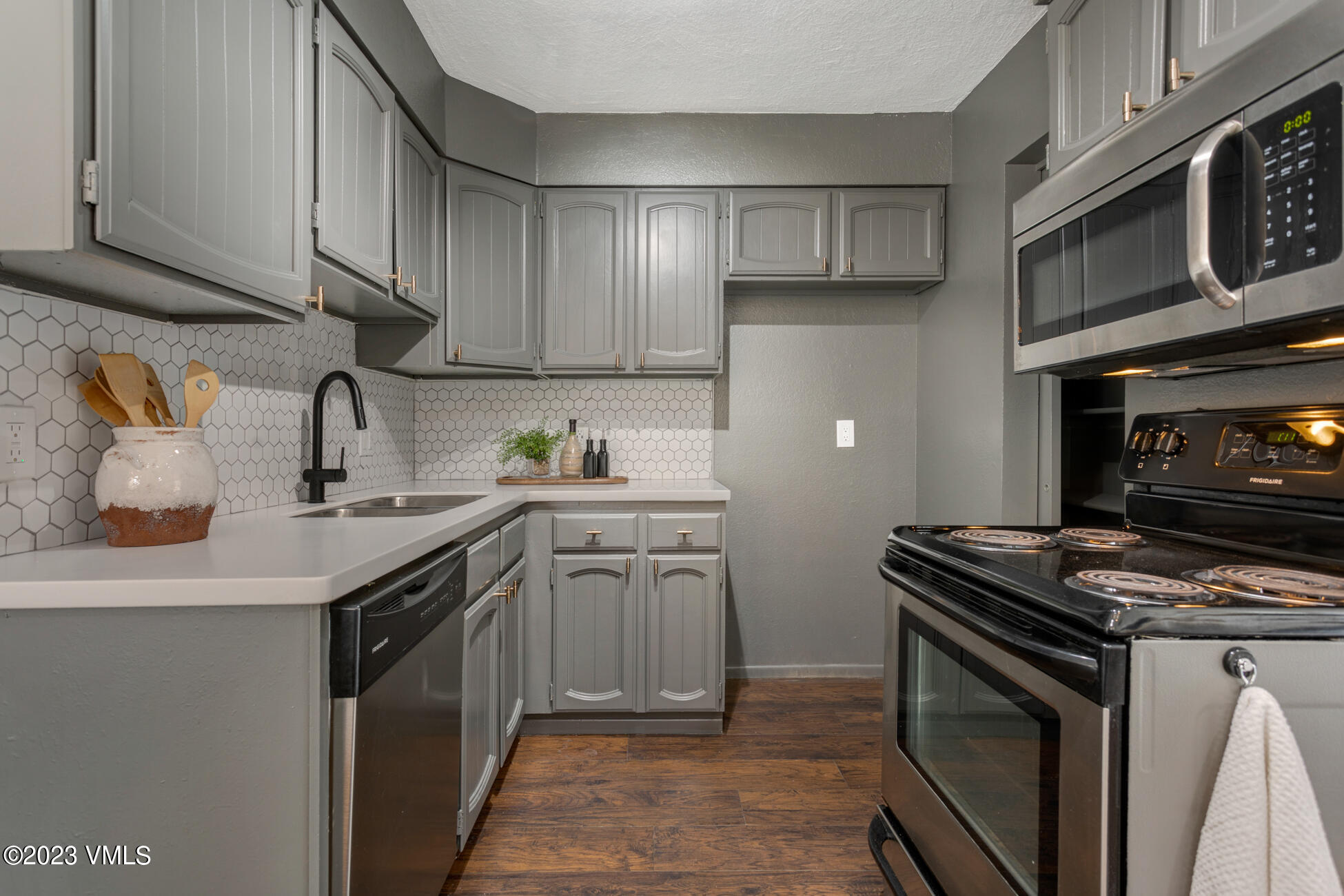 3910 Fall Line Drive, Unit 19 Vail, CO 81657 - Photo 10 of 40 a kitchen with stainless steel appliances granite countertop a sink stove top oven and cabinets