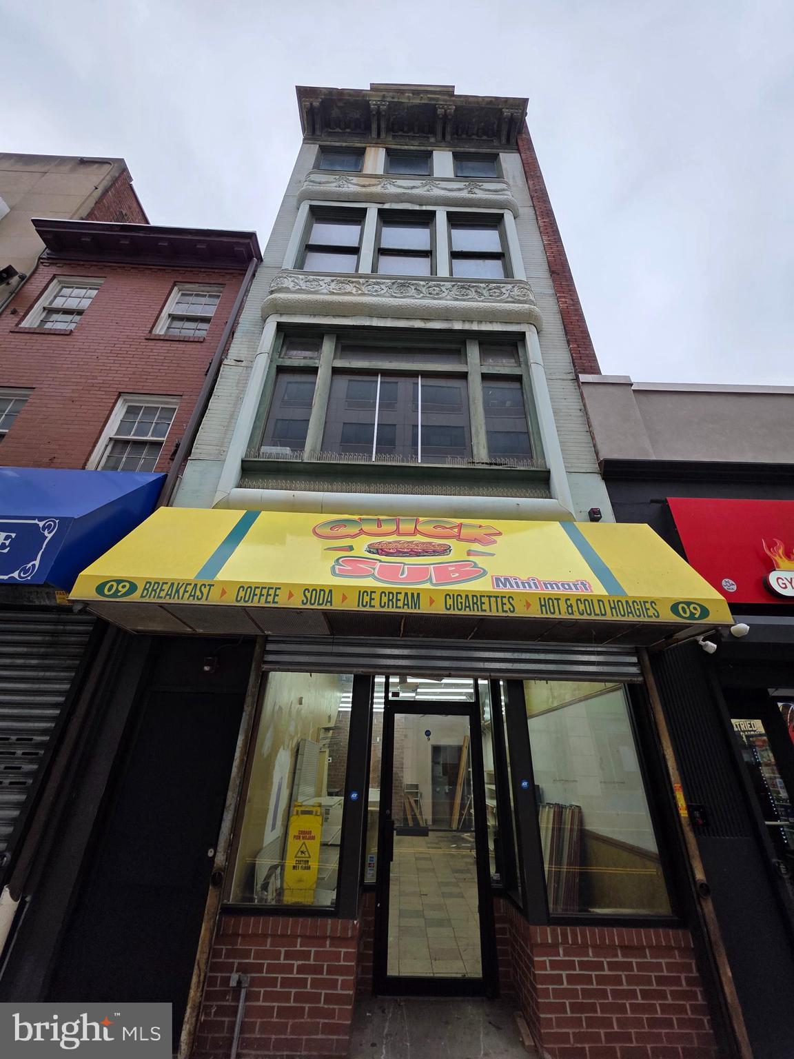 a view of a balcony with two chairs and a barbeque