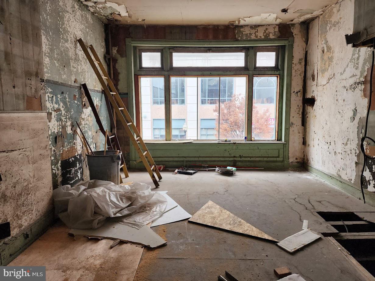 9 East State Street Trenton, NJ 08608 - Photo 20 of 29 a bed sitting in a room next to a window