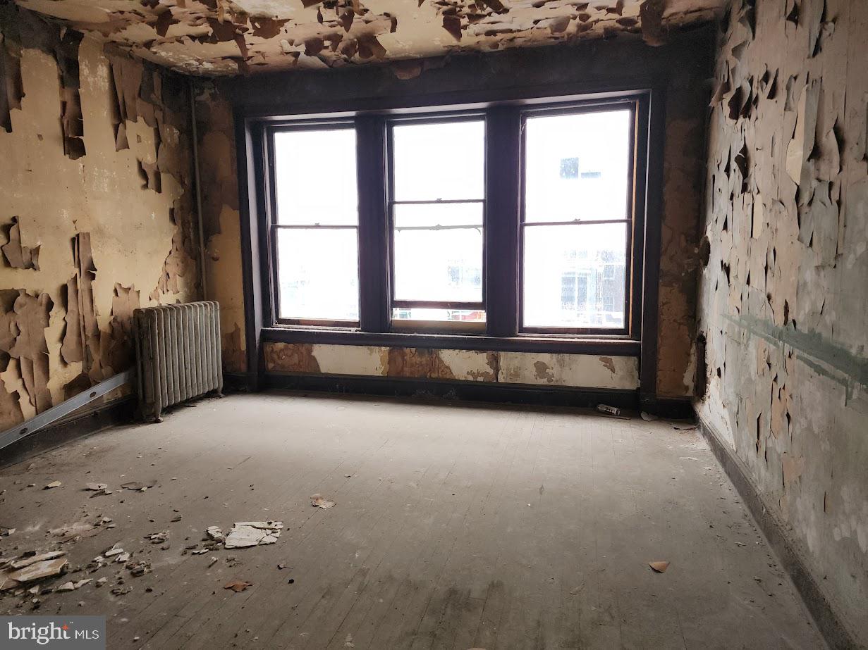 9 East State Street Trenton, NJ 08608 - Photo 22 of 29 wooden floor in an empty room with a window