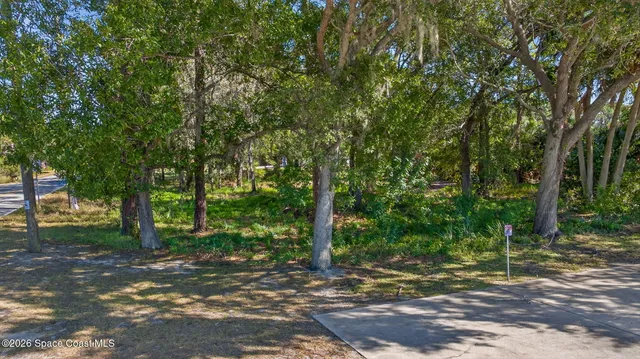 an aerial view of a house with garden space and street view
