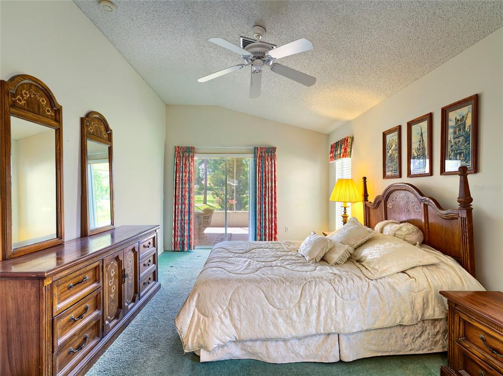 11228 Windrush Circle Hudson, FL 34667 - Photo 7 of 67 a bedroom with a bed and a chandelier