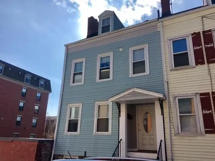 a view of a brick house with large windows