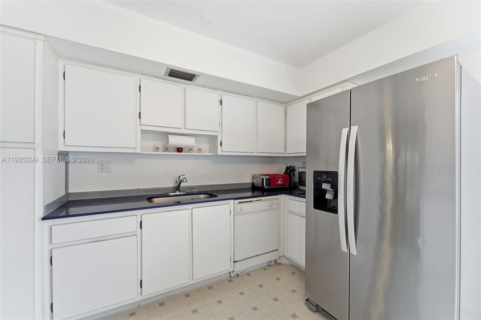 6561 Spring Bottom Way, Unit 234 Boca Raton, FL 33433 - Photo 16 of 33 a kitchen with stainless steel appliances a refrigerator sink and cabinets