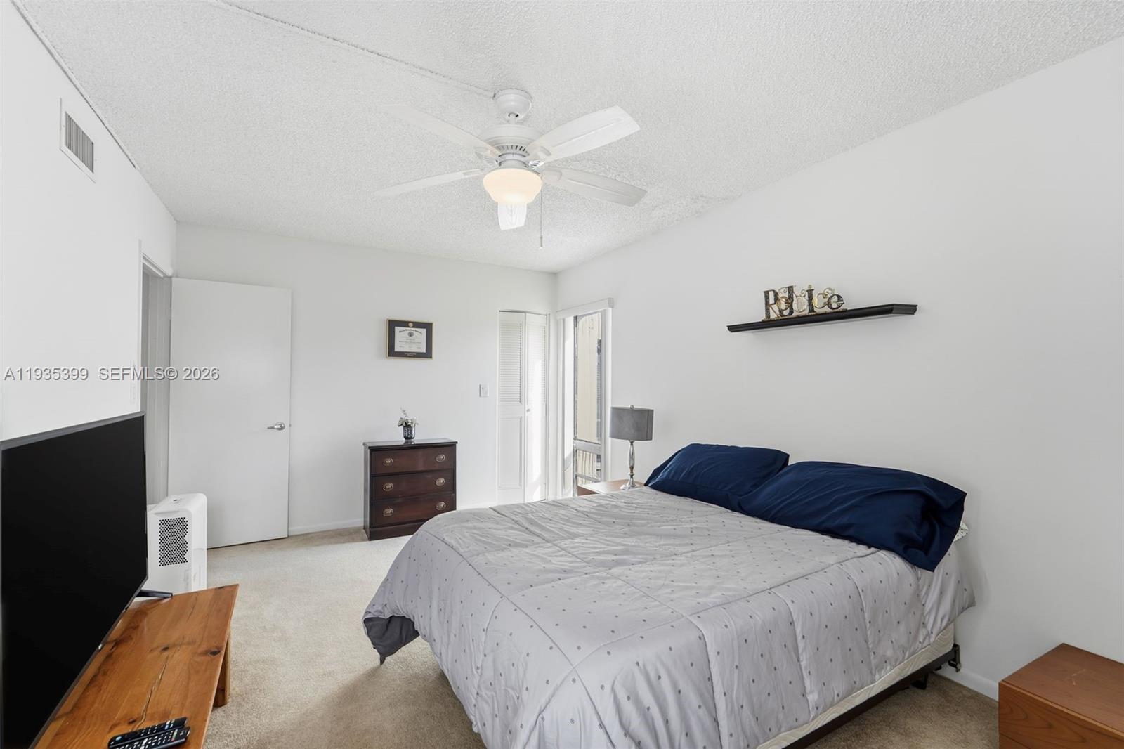 6561 Spring Bottom Way, Unit 234 Boca Raton, FL 33433 - Photo 18 of 33 a bedroom with a bed and a chandelier