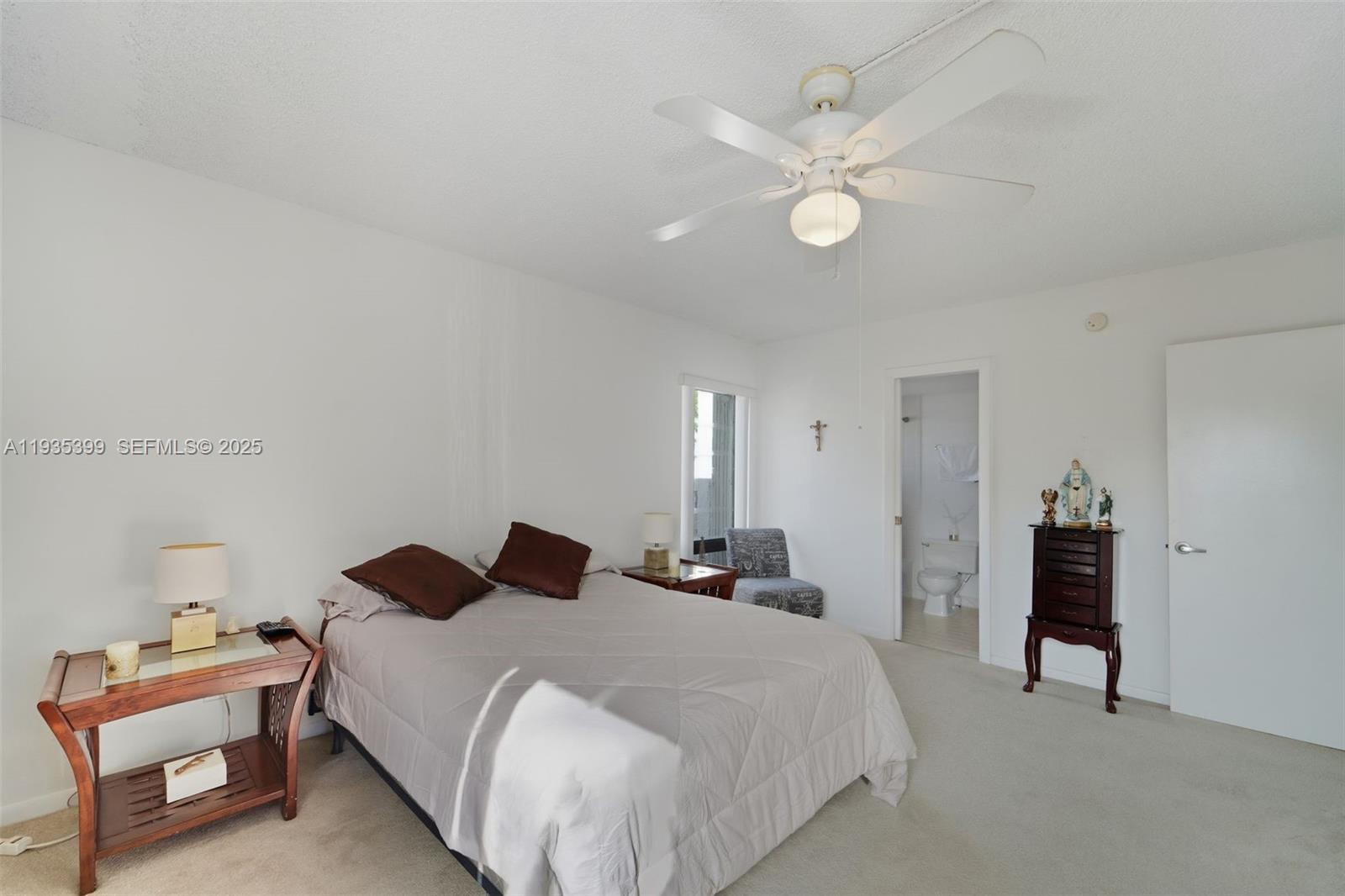 6561 Spring Bottom Way, Unit 234 Boca Raton, FL 33433 - Photo 18 of 31 a bedroom with a bed and a chandelier