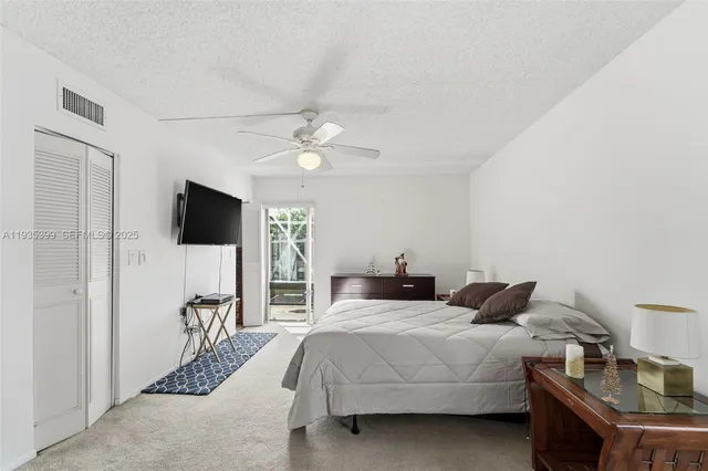 a bedroom with a bed window and a flat screen tv