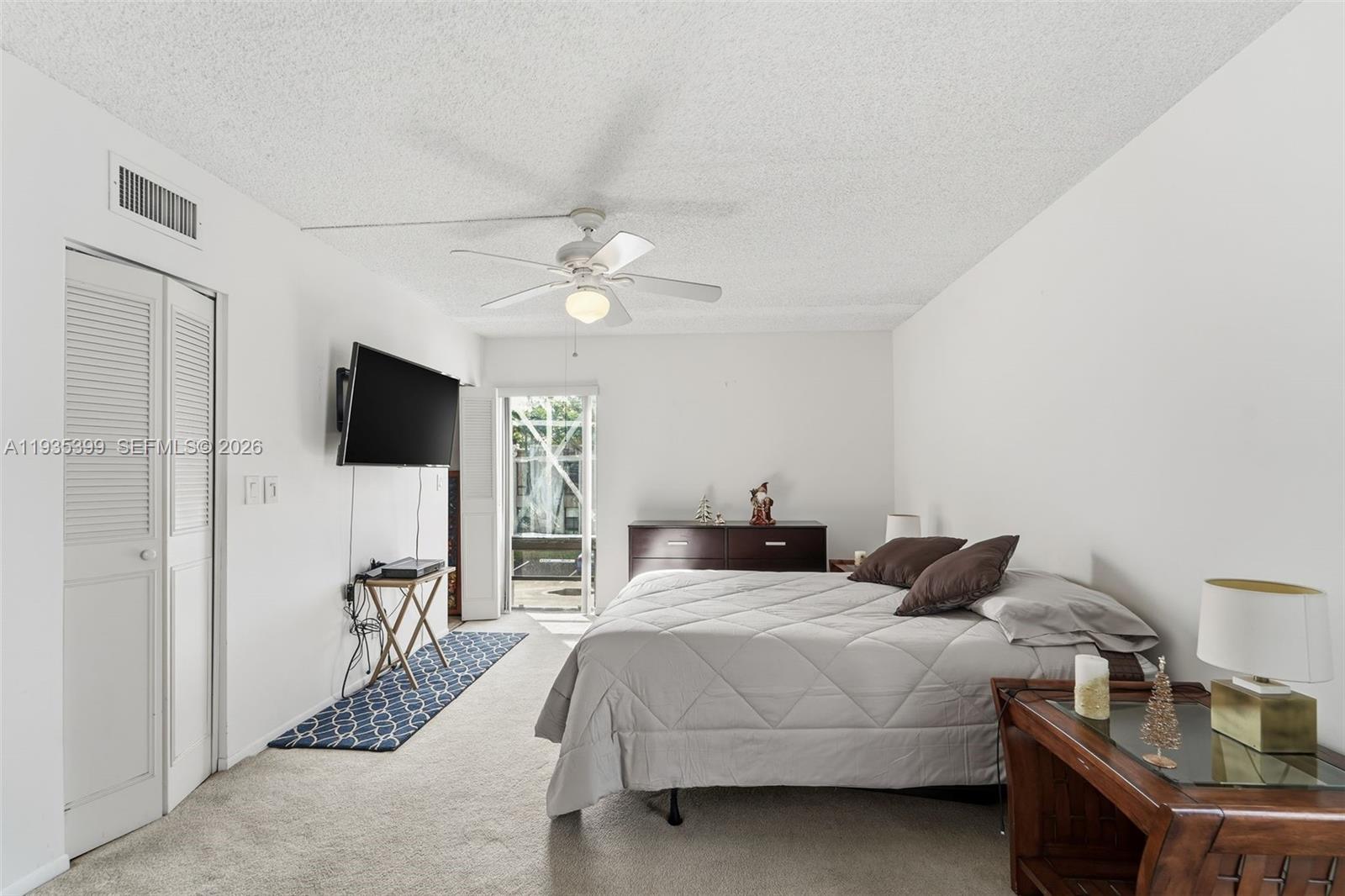 6561 Spring Bottom Way, Unit 234 Boca Raton, FL 33433 - Photo 22 of 33 a bedroom with a bed window and a flat screen tv